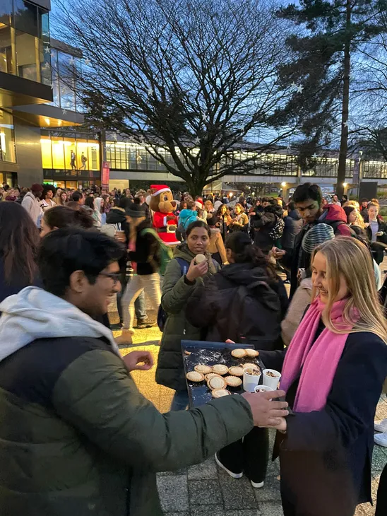 Queen's Court full of dancing people, helping themselves to free food