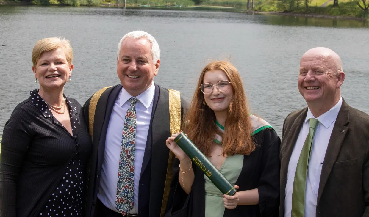Chancellor poses with family by loch after graduation