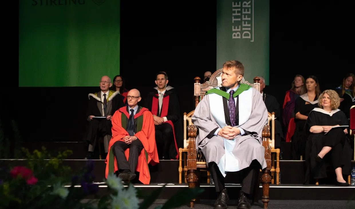 Honorary graduate Mike Robinson on stage at graduation