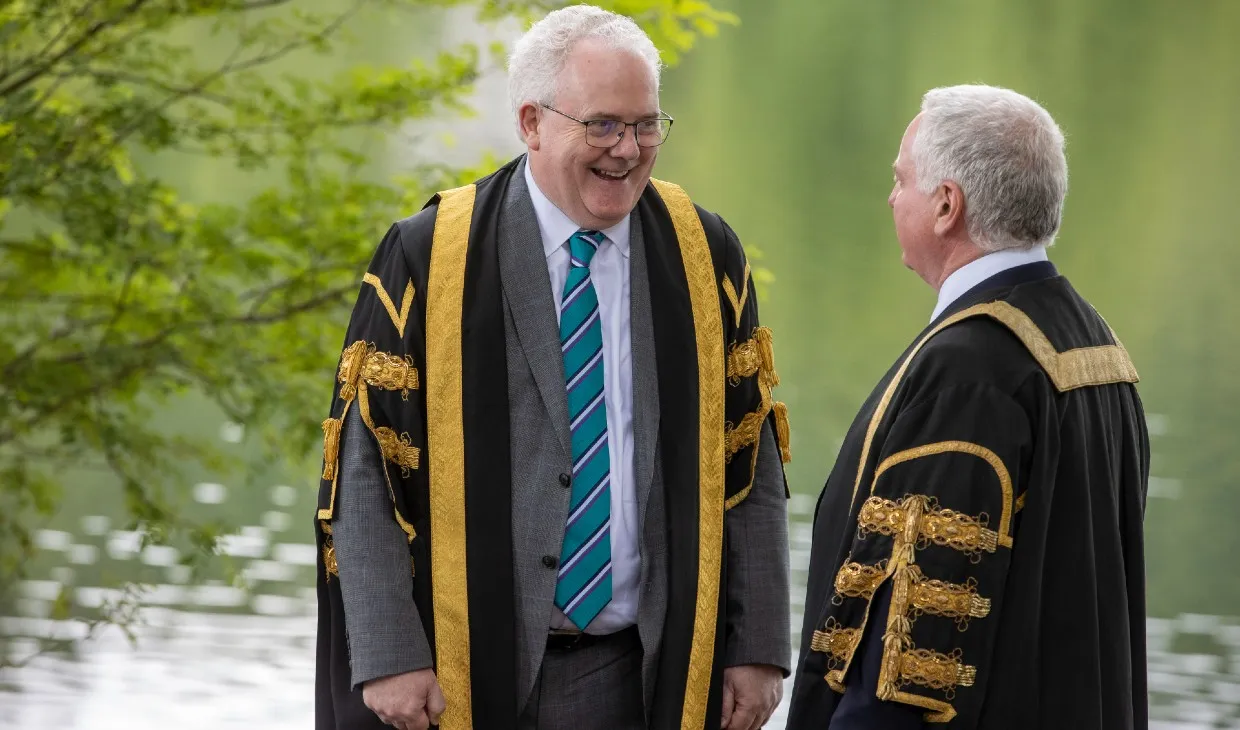 Chancellor and Principal chat next to the loch