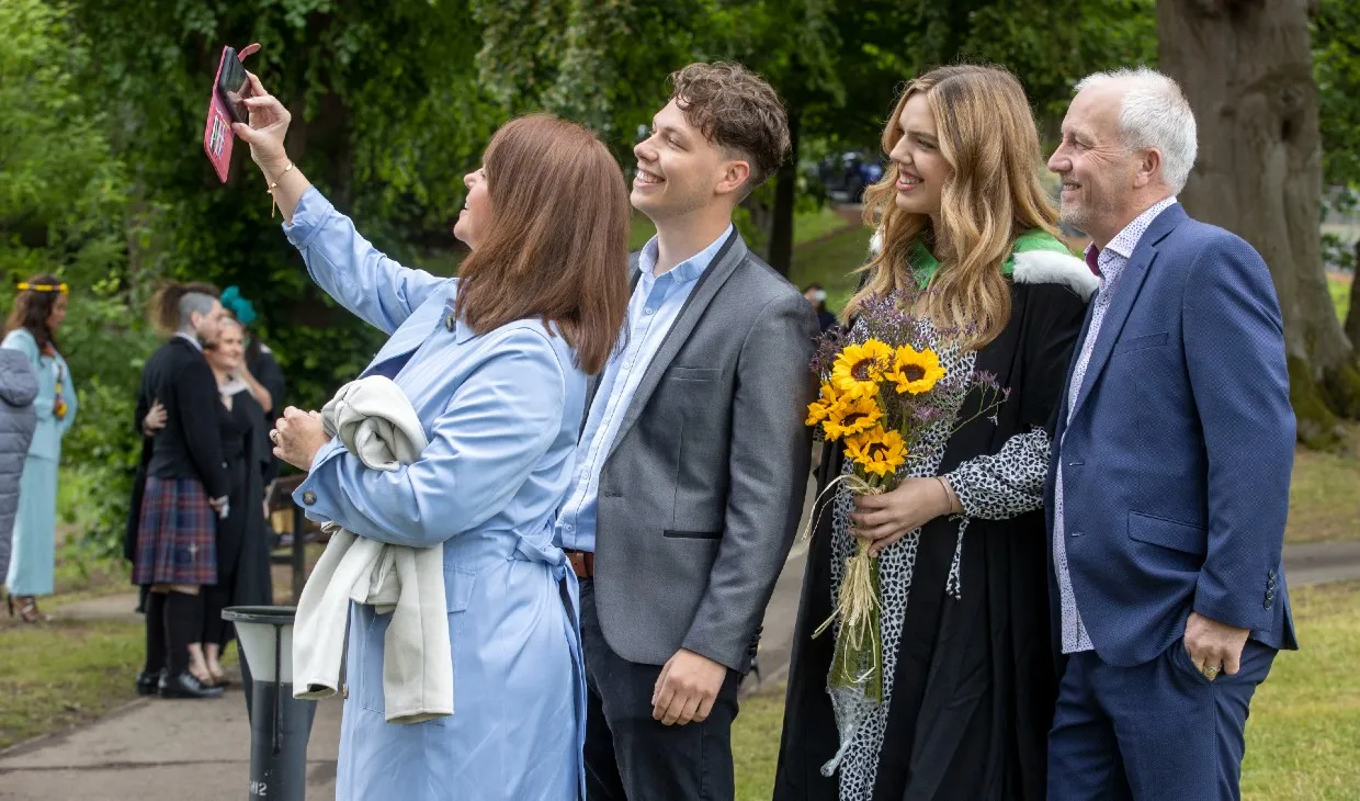 Family take a selfie at graduation