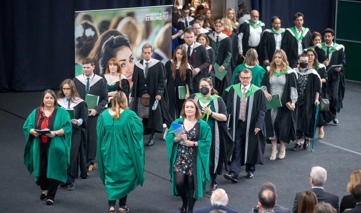 Graduands process in to the graduation hall