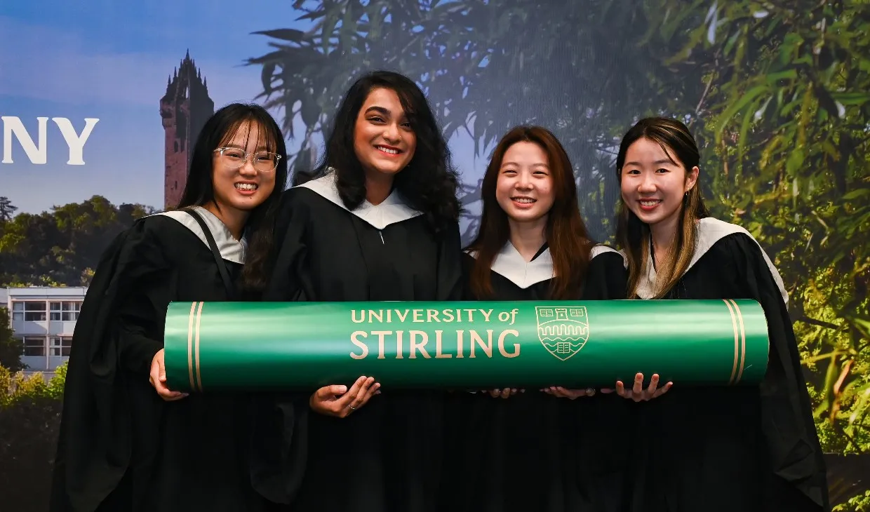 Happy Singapore graduates holding a prop degree from University of Stirling