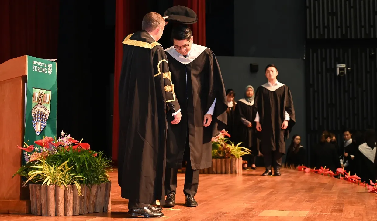 A graduate being capped during the Singapore graduation ceremony