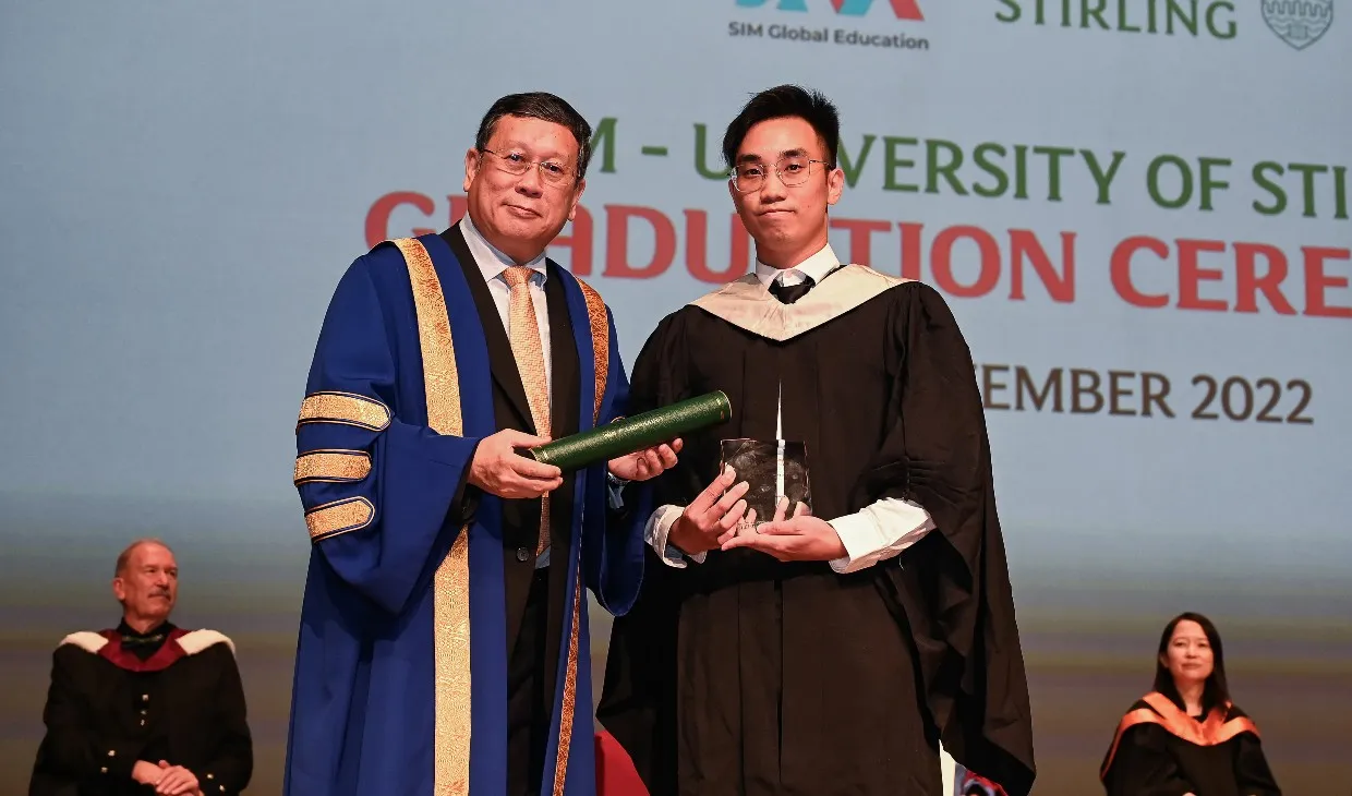 A Singapore graduate receiving an award during the ceremony
