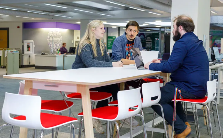 students at table in library