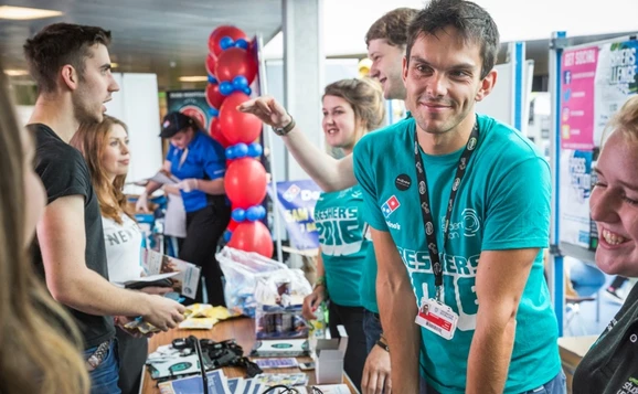 A student union representative at a stall during freshers week