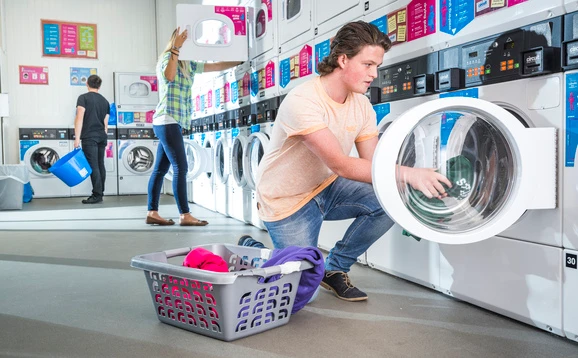 Student doing laundry at student accommodation