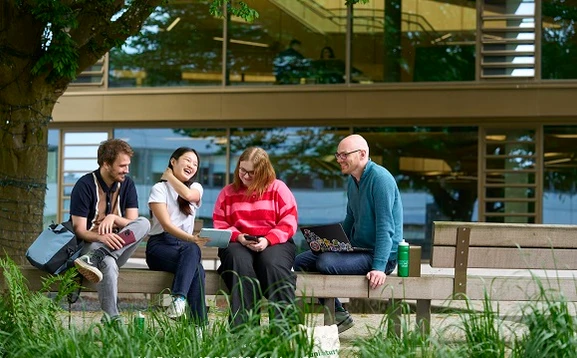 Group of students sitting on a bench