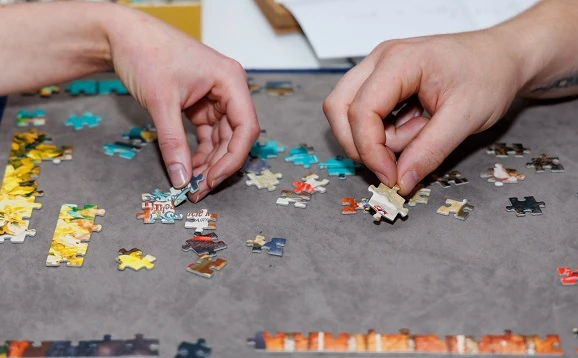 People doing a jigsaw puzzle 578x358