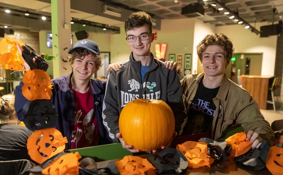 Students carving pumpkins for Halloween