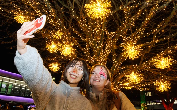 Students take selfie at Christmas lights switch on