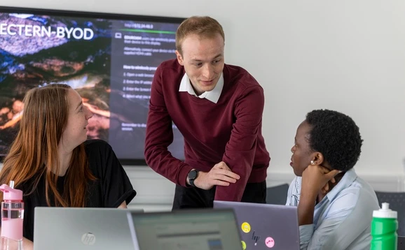 Lecturer speaking to students in a classroom