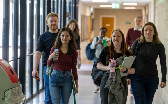Group of students walking down the link bridge