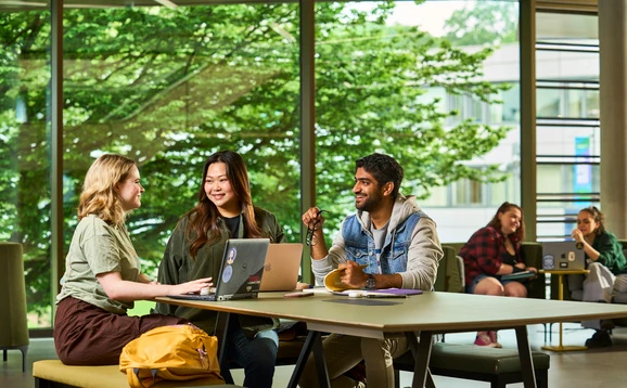 Students talking at a table in campus central