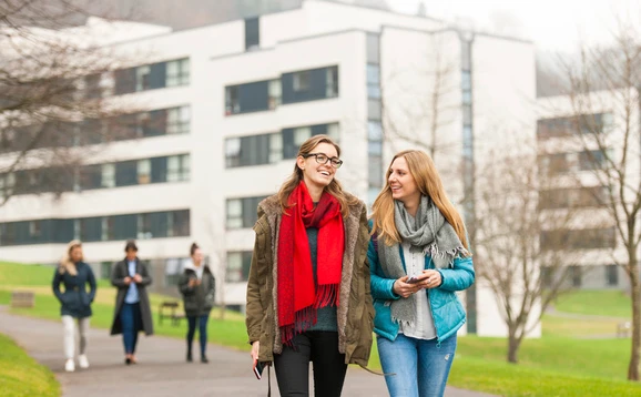 Two students walking on campus near the accommodation buildings