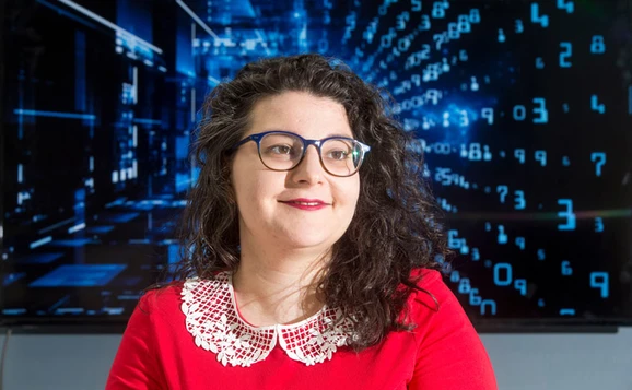 student wearing glasses in front of screen