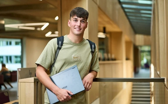 Student holding a laptop