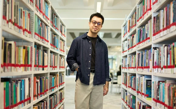 Student standing in the library