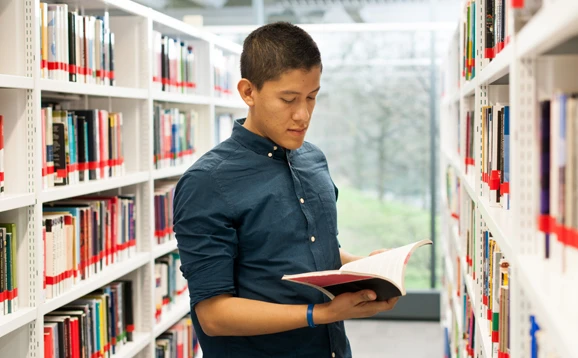 student reading in library