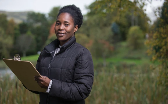 Student holding a clipboard outdoors