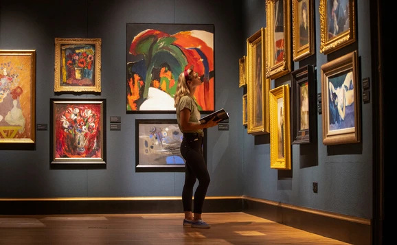 Student looking at art in gallery