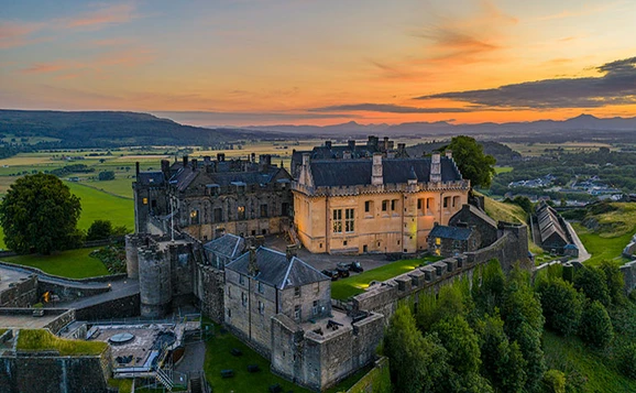 From the air shot of Stirling Castle with a sunset in the background