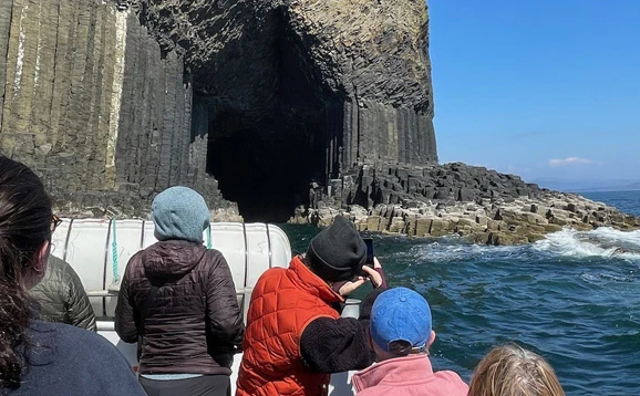 People on a boat heading towards Staffa