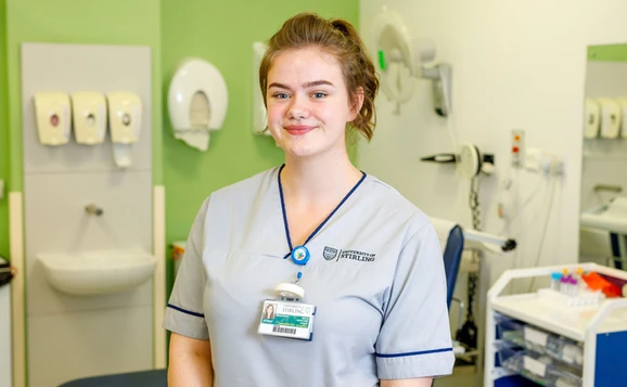 Nursing student standing in a training ward