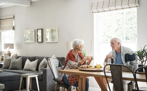 Two people sitting at table in home