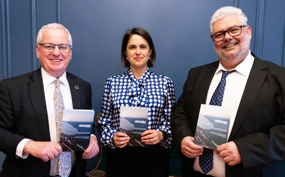 three people holding booklets