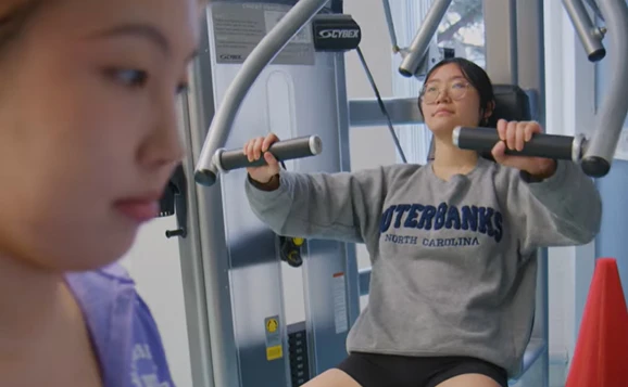 person using weights machine