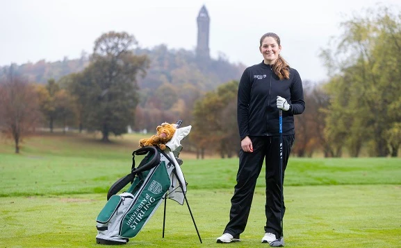 Golfer in front of Wallace Monument