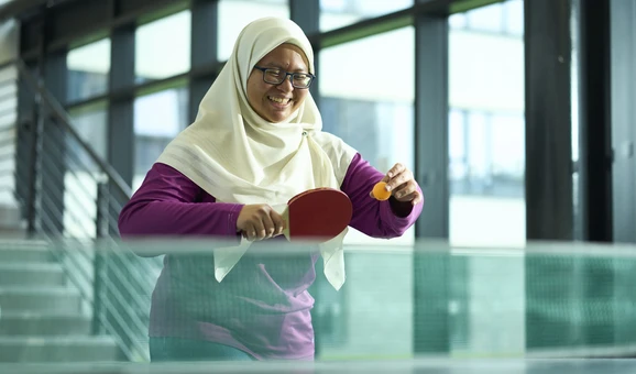 student playing table tennis