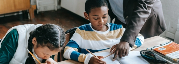 Girl and boy at desk at school