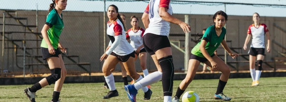 women playing football