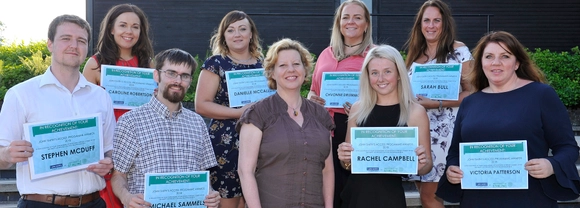Group of students with certificates