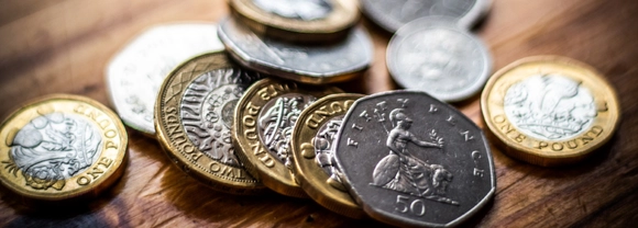 UK coins spread across a table
