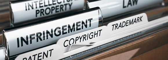 3D illustration of a folder, focus on a tab with the word infringement.
