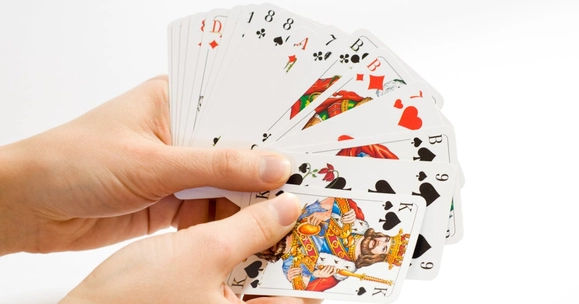 hands holding deck of cards