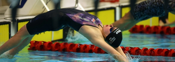 Swimmer Holly McGill dives into the pool.