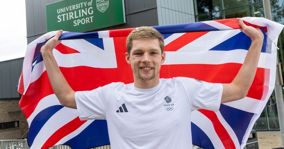Duncan Scott poses with Union Flag outside University of Stirling Sports Centre.