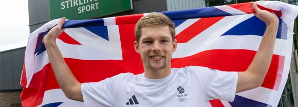 Duncan Scott poses with Union flag outside the University of Stirling.