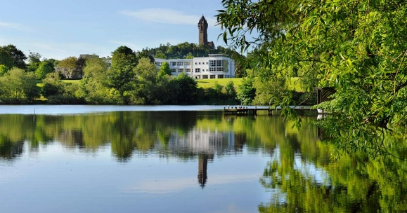 loch with building and trees