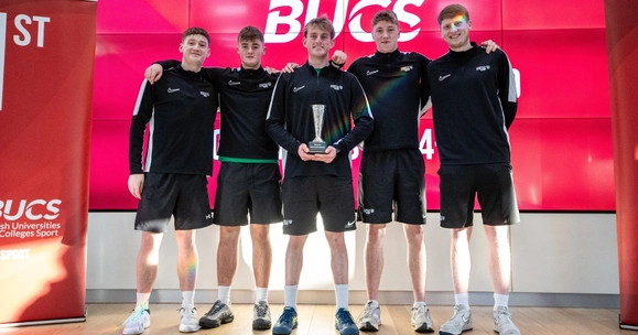 Stirling men's tennis team pose for photo with trophy.