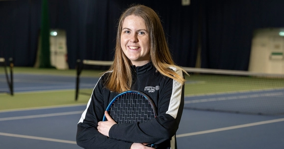 Anna McBride poses with tennis racquet.