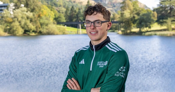 Alex Robin, triathlete, poses in front of Airthrey Loch.