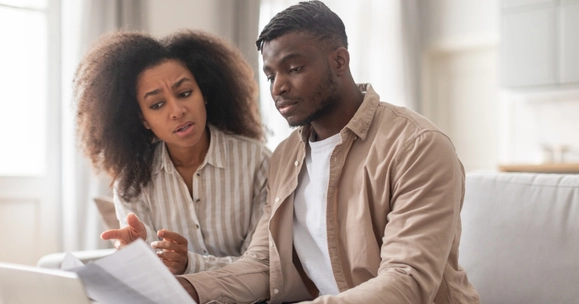 two people worried looking at paperwork