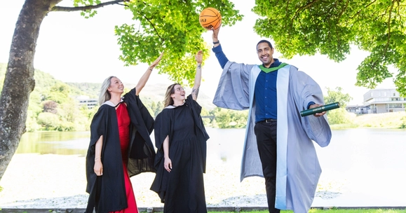Kieron Achara with two graduating students.
