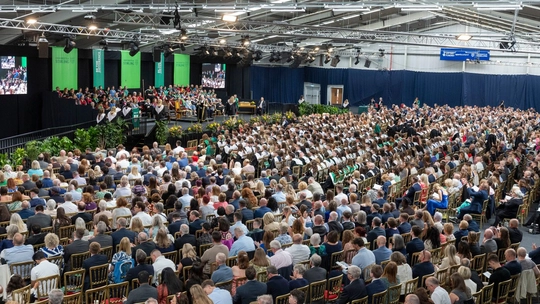 A graduation ceremony in front of a packed hall at the ���ϲ�����